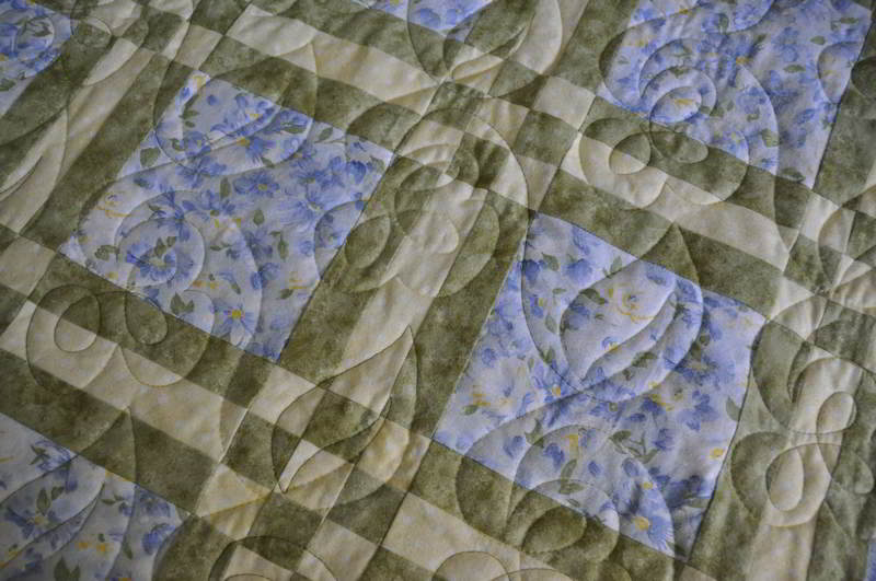 Close up of the quilt blocks, fabrics and quilting pattern.