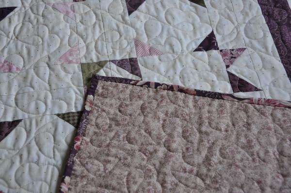 A shot of the backing fabric against the front of the quilt.