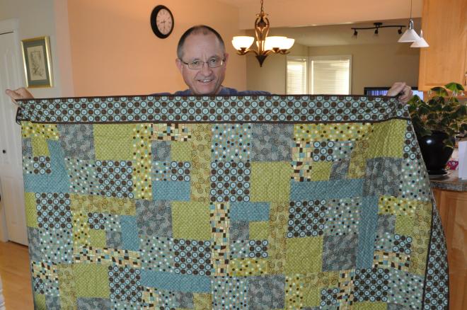 Rick Brugos accepts his new lap quilt, City Slicker #2.