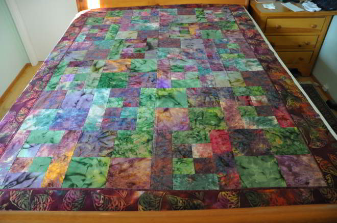 A 4th City Slicker quilt in purple and green batiks.