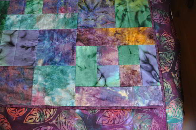 A close up shot of one of the corners of the quilt top.