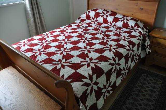 A shot of the full red and white Hunter's Star quilt on our bed.
