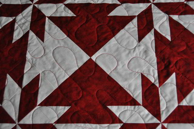 Close up of a section of the quilt showing four arrow heads.