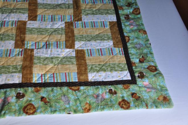 A closer look at the design, 'Jungle Babies' and other fabrics used in the quilt.