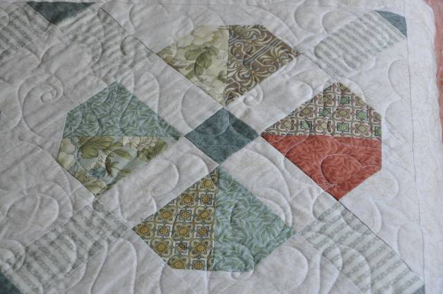 A close look at a single marigold and the quilting pattern.