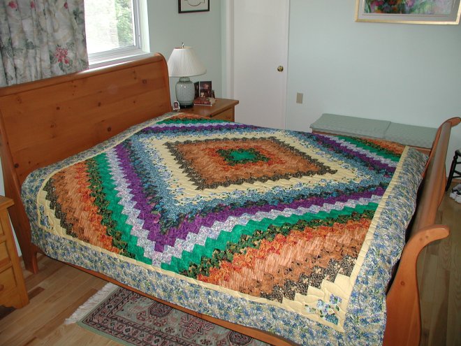 Quilt using the Quick Trip Around the World technique. This is from the class she took. All the fabrics except the outside border and backing were obtained from Barbara's stash 