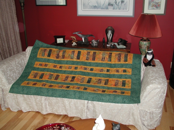 Lap quilt in greens and golds, made from kit purchased in Lethbridge, Alberta in September 2005.