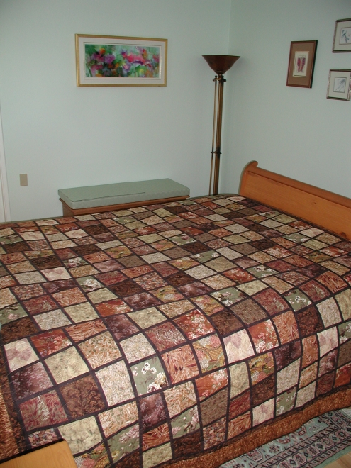 Barbara's second Magic Tiles quilt, done in earth coloured fabrics, is
      a wedding gift for Kevin and Stephanie.