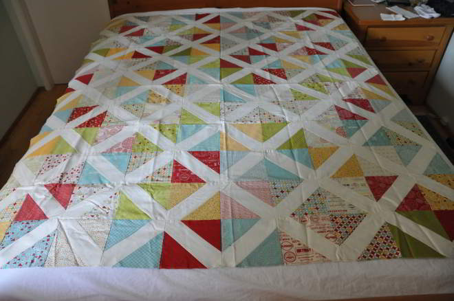 A quilt of many colours, including blue, green, red and yellow.