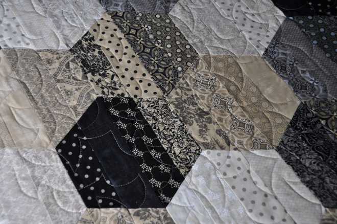 A close-up of the piecing, strips, for the quilt top.