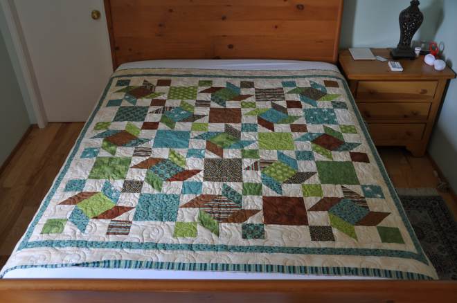 The almost bound Scrappy Windmills quilt from a kit bought in Lethbridge at Village Quilts.