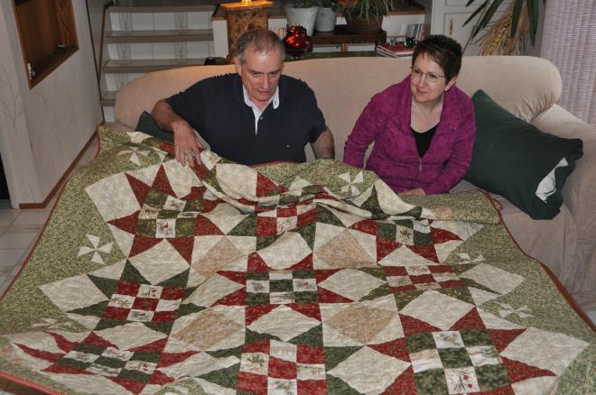 Arthur and Myra accept their new quilt, Very Merry.